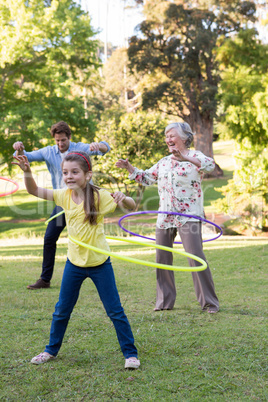 Extended family playing with hula hoops