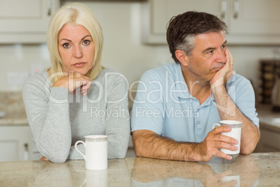 Mature couple having coffee together not talking