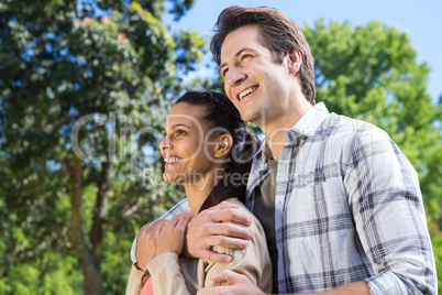 Happy couple hugging in park