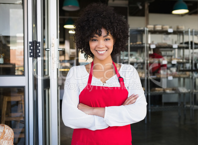 Pretty server in red apron with arms crossed Pretty server in red apron with arms crossed