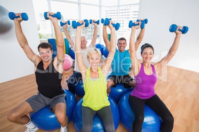People lifting weights in gym class