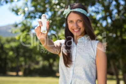 Pretty brunette using her inhaler