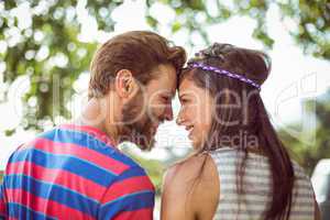 Hipster couple smiling at each other