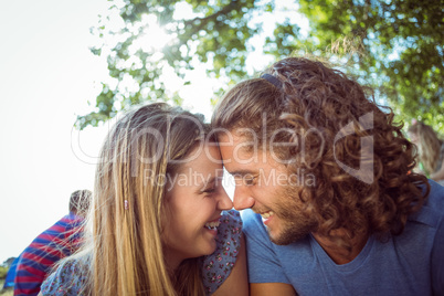 Hipster couple smiling at each other