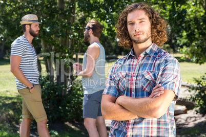 Young man frowning at camera in the park