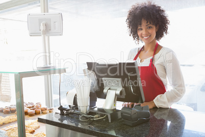 Beautiful waitress posing behind the counter
