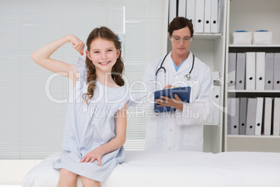 Smiling little girl putting her arm up