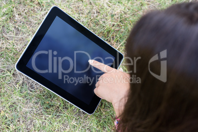 Woman using tablet in park