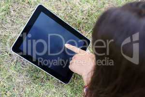 Woman using tablet in park