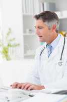 Doctor using computer keyboard at table