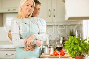 Mature couple preparing vegetarian meal together
