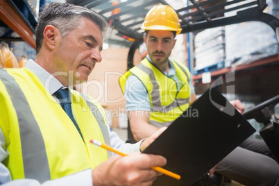 Forklift driver talking with his manager