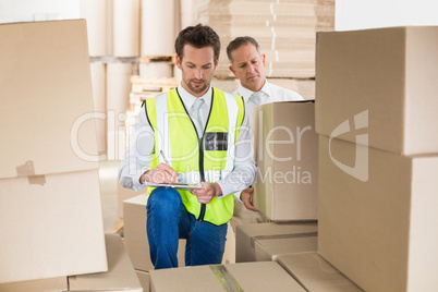 Delivery driver checking his list on clipboard