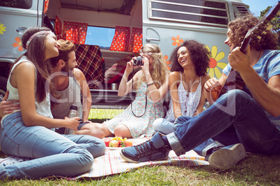 Hipster friends by camper van at festival