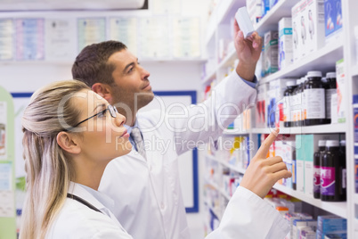 Team of pharmacists looking at medicine