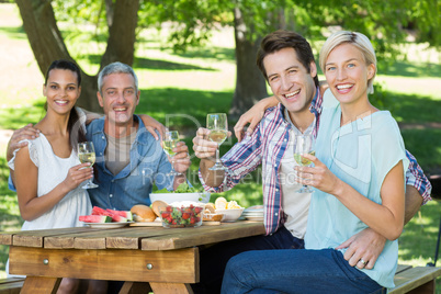 Happy couples drinking at the park