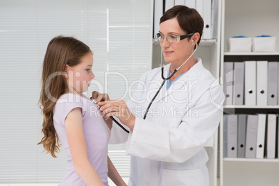 Doctor examining little girl