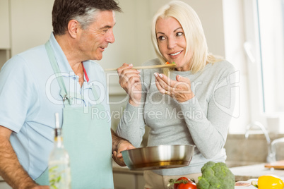 Happy mature couple making dinner together