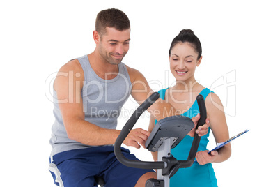 Trainer with client on exercise bike