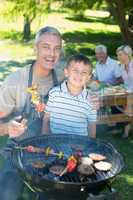 Happy father doing barbecue with his son