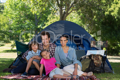 Happy family on a camping trip in their tent