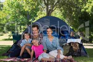 Happy family on a camping trip in their tent