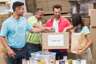 Warehouse workers packing up donation boxes