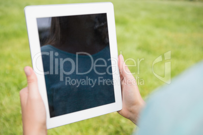 Woman using tablet in park