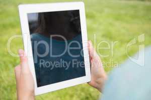 Woman using tablet in park