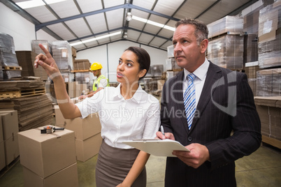 Warehouse manager showing something to her boss