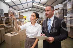 Warehouse manager showing something to her boss