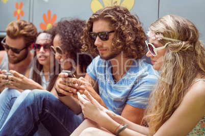 Hipster friends using their phones