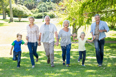 Happy family running in the park