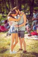 Hipster couple smiling and hugging