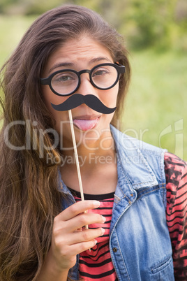 Pretty brunette with fake mustache