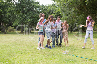 Young friends having fun with powder paint