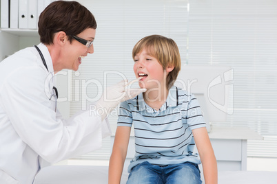 Doctor examining a little boy with stem