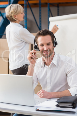 Warehouse manager using laptop during a presentation