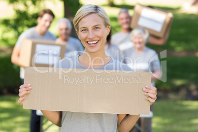 Happy volunteer blonde holding blank