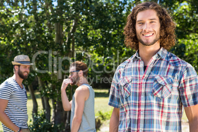Hipster smiling at camera in the park
