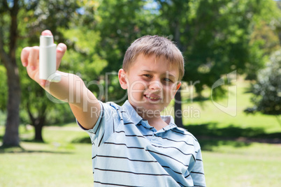 Little boy showing his inhaler