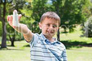 Little boy showing his inhaler