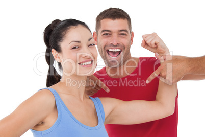 Fit woman and trainer smiling at camera