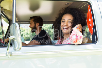 Hipster couple driving in camper van