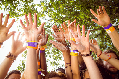 Happy hipsters with hands up