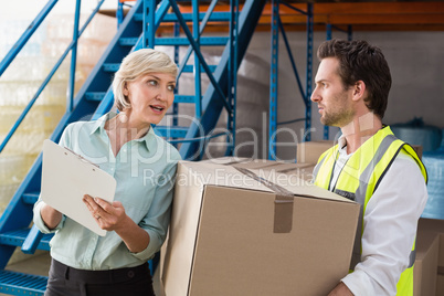 Warehouse manager and worker talking together