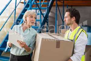 Warehouse manager and worker talking together