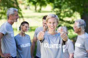 Happy volunteer blonde with thumbs up