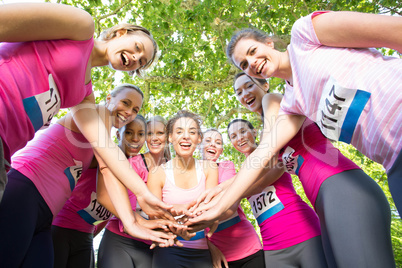 Smiling women running for breast cancer awareness