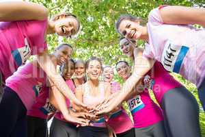 Smiling women running for breast cancer awareness